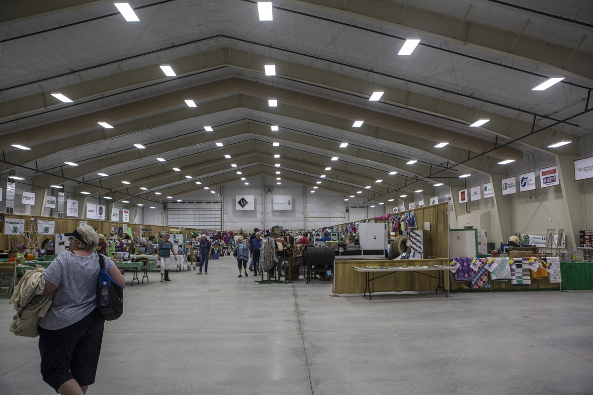 Wide interior photo of the Nordby Exhibit Hall with exhibits and visitors. 